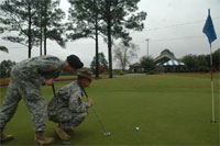 James Gilbert, left, and Larry Jackson try to gauge a putt at the Fort Jackson Golf Club.