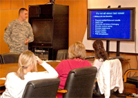 Capt. Josh Metz, a chaplain with U.S. Army Garrison Wiesbaden Religious Services Office, talks about the benefits of military life during a Spouse Battlemind training session with spouses of Special Troops Battalion, 1st Armored Division, Soldiers.